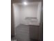 Bright kitchenette featuring granite countertops and white cabinetry with gray wood-look floors at 1317 Exley Ave, Las Vegas, NV 89104
