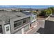Aerial view of modern townhomes featuring grey exterior paint and garage entries at 143 Aqua Commons Ln, Henderson, NV 89015