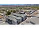 Drone image of gray, modern townhouses featuring a landscaped community in a residential neighborhood at 143 Aqua Commons Ln, Henderson, NV 89015