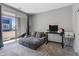 Comfortable bedroom with balcony access, neutral tones, cozy furnishings and a dedicated workspace at 143 Aqua Commons Ln, Henderson, NV 89015