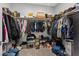 Walk-in closet with clothes and shoes, featuring built-in shelving and clothing racks at 143 Aqua Commons Ln, Henderson, NV 89015
