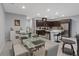 Open-concept dining room flows into a modern kitchen with stainless steel appliances and bar seating at 143 Aqua Commons Ln, Henderson, NV 89015