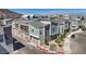 Charming townhome complex featuring modern architecture, stylish gray facades, and well-manicured landscaping, showcasing community appeal at 143 Aqua Commons Ln, Henderson, NV 89015
