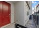 Townhouse exterior with bright red front door and paver walkway, surrounded by fence at 143 Aqua Commons Ln, Henderson, NV 89015