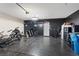 Spacious garage featuring speckled flooring, black accent wall, workout equipment, and ample storage solutions at 143 Aqua Commons Ln, Henderson, NV 89015