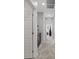 Hallway featuring carpet flooring, light grey walls, and white doors with black hardware at 143 Aqua Commons Ln, Henderson, NV 89015