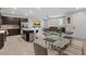 Open-concept dining and living area boasts hardwood floors, modern furniture, and large windows at 143 Aqua Commons Ln, Henderson, NV 89015
