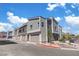 View of townhouses featuring gray color scheme, attached garages and modern architecture at 143 Aqua Commons Ln, Henderson, NV 89015