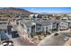 Aerial shot of modern townhouses with two-car garages, neutral toned exterior, and mountain views at 143 Aqua Commons Ln, Henderson, NV 89015