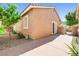 Exterior view of the backyard with a small patio, desert landscaping, and a well-maintained fence at 1440 Summer Glow Ave, Henderson, NV 89012