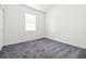 Bright bedroom features a large window for natural light and neutral gray carpet at 1440 Summer Glow Ave, Henderson, NV 89012