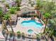The community pool offers lounge chairs, palm trees, a separate hot tub, and a gazebo at 1440 Summer Glow Ave, Henderson, NV 89012
