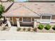 A front view of the home's entrance, with a covered porch, white pillars, and desert landscaping at 1440 Summer Glow Ave, Henderson, NV 89012