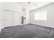 Main bedroom showcases plush gray carpet, neutral walls, and a window for natural light at 1440 Summer Glow Ave, Henderson, NV 89012