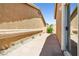 View of the side yard with a walkway and minimal landscaping, showing the property's exterior at 1440 Summer Glow Ave, Henderson, NV 89012