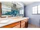 Bright bathroom features a double sink vanity and a framed mirror at 1727 Cherokee Ln, Las Vegas, NV 89169