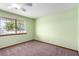 Well-lit bedroom features a large window and neutral carpet at 1727 Cherokee Ln, Las Vegas, NV 89169