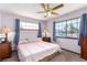 Cozy bedroom with large windows, a ceiling fan, and light pink bedding at 1727 Cherokee Ln, Las Vegas, NV 89169