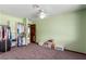 This bedroom features an open closet, a ceiling fan, and natural light at 1727 Cherokee Ln, Las Vegas, NV 89169