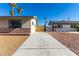 Charming single story home featuring well-maintained landscaping, attractive desert rock, and secure driveway gate at 1727 Cherokee Ln, Las Vegas, NV 89169