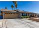 Charming single story home with a long driveway leading to a two-car garage, and well maintained desert rock front yard at 1727 Cherokee Ln, Las Vegas, NV 89169