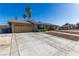 Charming single story home with a long driveway leading to a two-car garage, and well maintained desert rock front yard at 1727 Cherokee Ln, Las Vegas, NV 89169