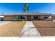 Charming single story home featuring well-maintained landscaping, and attractive desert rock at 1727 Cherokee Ln, Las Vegas, NV 89169