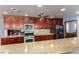 Updated kitchen with dark cabinetry, stainless steel appliances, and granite countertops at 1727 Cherokee Ln, Las Vegas, NV 89169