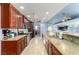 Galley kitchen with stainless steel appliances, ample counter space, and tile flooring at 1727 Cherokee Ln, Las Vegas, NV 89169