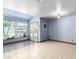 Open living room with tile flooring, large windows, and a view of the backyard at 1727 Cherokee Ln, Las Vegas, NV 89169