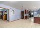 Open living space with tile floors adjacent to the kitchen, wooden trim, and arched doorway at 1727 Cherokee Ln, Las Vegas, NV 89169