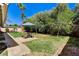Lush backyard with mature trees and an outdoor seating area at 1940 Canterbury Dr, Las Vegas, NV 89119