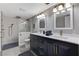 Stylish bathroom featuring a double vanity, modern fixtures, and a sleek glass-enclosed shower at 1940 Canterbury Dr, Las Vegas, NV 89119