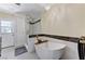 A stylish bathroom with a modern tub and glass-enclosed shower at 1940 Canterbury Dr, Las Vegas, NV 89119