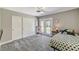 Comfortable bedroom featuring a ceiling fan, plush carpet, and sliding door access to the backyard at 1940 Canterbury Dr, Las Vegas, NV 89119