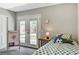 Comfortable bedroom featuring a ceiling fan, plush carpet, and sliding door access to the backyard at 1940 Canterbury Dr, Las Vegas, NV 89119