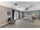 Bright bedroom with a decorative accent wall, a ceiling fan, and double doors to the backyard at 1940 Canterbury Dr, Las Vegas, NV 89119