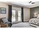 Spacious bedroom featuring double doors leading to the backyard and a comfortable sitting area at 1940 Canterbury Dr, Las Vegas, NV 89119