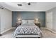 Modern bedroom with plush carpet, blue accent wall, and matching nightstands at 1940 Canterbury Dr, Las Vegas, NV 89119