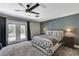Bright bedroom with double doors to the backyard, complemented by modern ceiling fan at 1940 Canterbury Dr, Las Vegas, NV 89119