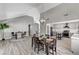 Open-concept dining room featuring modern lighting and laminate floors, flowing into the kitchen at 1940 Canterbury Dr, Las Vegas, NV 89119