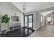 Welcoming foyer featuring a black tiled floor, mirrored console and exterior views at 1940 Canterbury Dr, Las Vegas, NV 89119