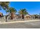 Charming home with mature palm trees in a gated front yard at 1940 Canterbury Dr, Las Vegas, NV 89119