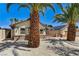 Home with brick accents, wood garage doors and solar panels at 1940 Canterbury Dr, Las Vegas, NV 89119
