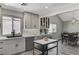 Modern kitchen featuring a large window, stainless steel appliances, and a view to an adjacent dining area at 1940 Canterbury Dr, Las Vegas, NV 89119