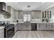 Beautiful renovated kitchen with gray cabinets, modern appliances, and hardwood floors at 1940 Canterbury Dr, Las Vegas, NV 89119