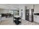 Bright, modern kitchen open to a dining area with stainless steel appliances, gray cabinets, and an island at 1940 Canterbury Dr, Las Vegas, NV 89119