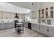 Modern kitchen with gray cabinetry, a sleek black range hood, white subway tile backsplash, and stylish decor at 1940 Canterbury Dr, Las Vegas, NV 89119