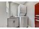 Efficient laundry area featuring a stacked washer/dryer and a sink with modern cabinetry at 1940 Canterbury Dr, Las Vegas, NV 89119