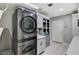 Modern laundry room with washer/dryer, utility sink, and custom storage cabinets for organization at 1940 Canterbury Dr, Las Vegas, NV 89119